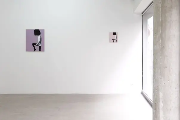 Two hanged paintings of a kneeling person