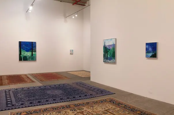 Three landscape paintings hanging on the wall