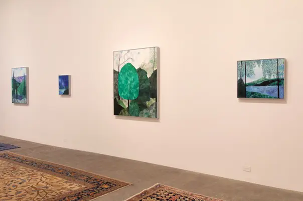 Four displayed landscape paintings