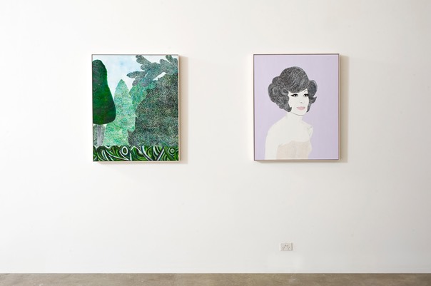 Two paintings displayed on a gallery wal